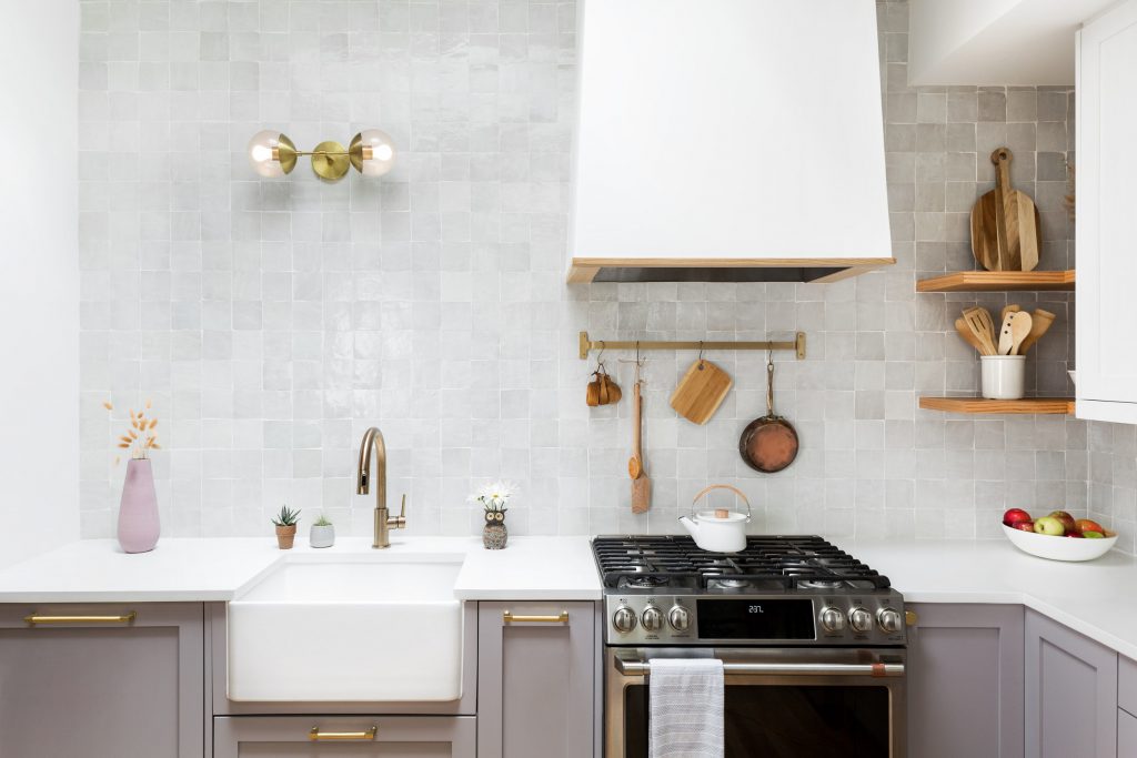 a white tile backsplash