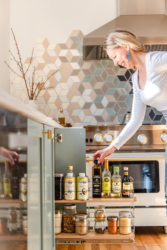 amanda paa choosing spices from a spice drawer.