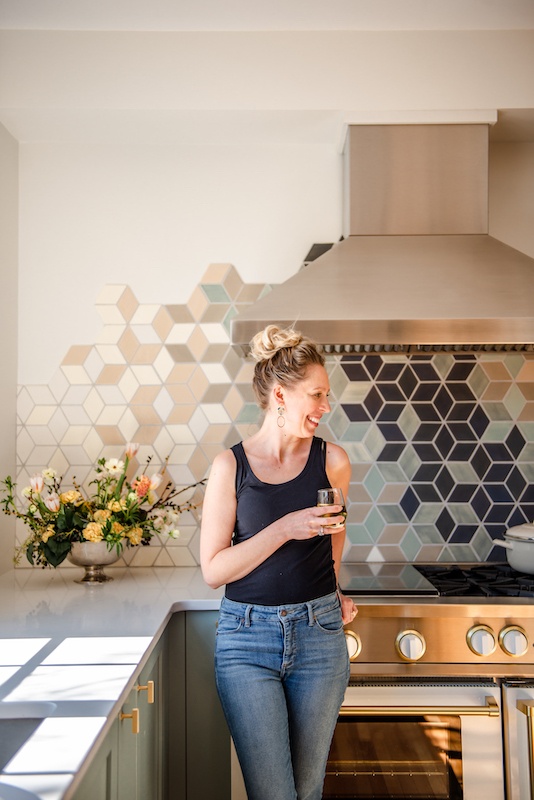 amanda paa in her kitchen with a glass of wine