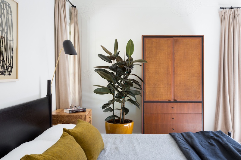 close up of master bed and armoire