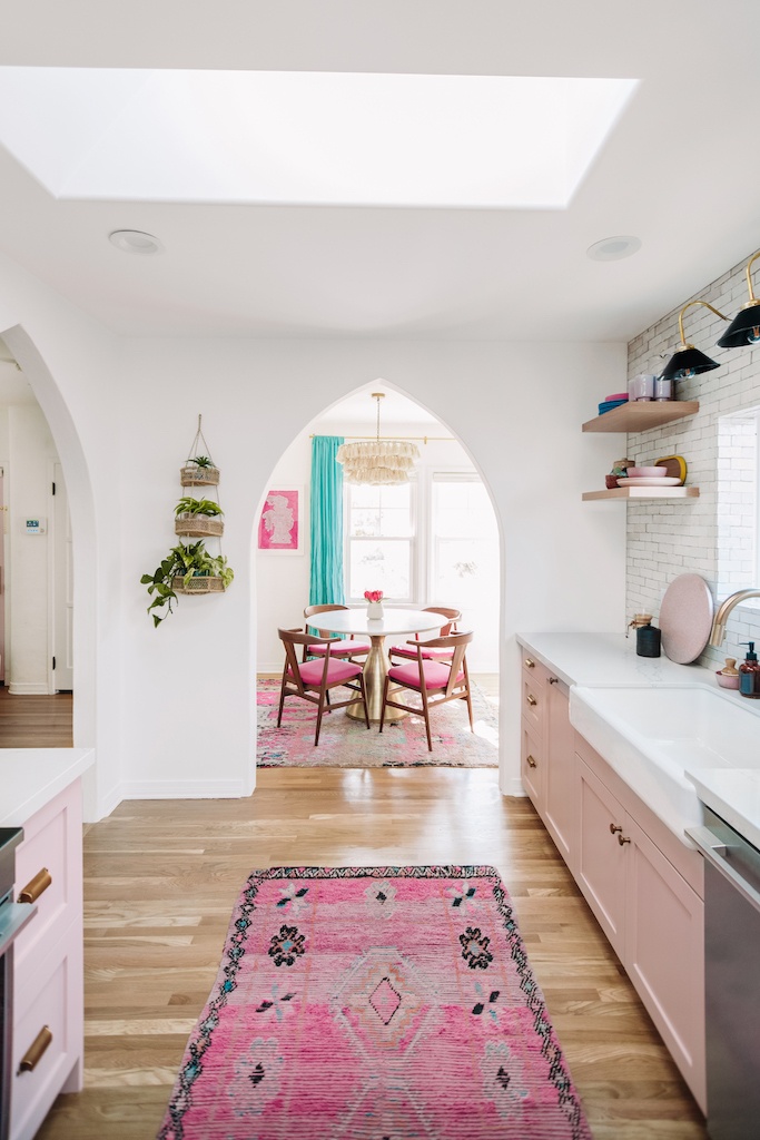 the kitchen opens to a dining room through a curved archway