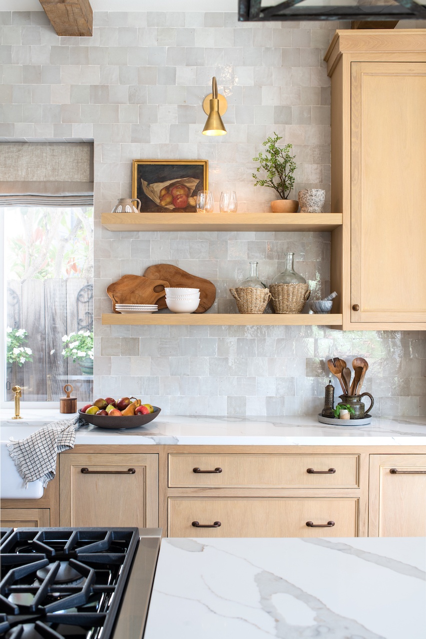 a kitchen with wood open shelving and cabinetry