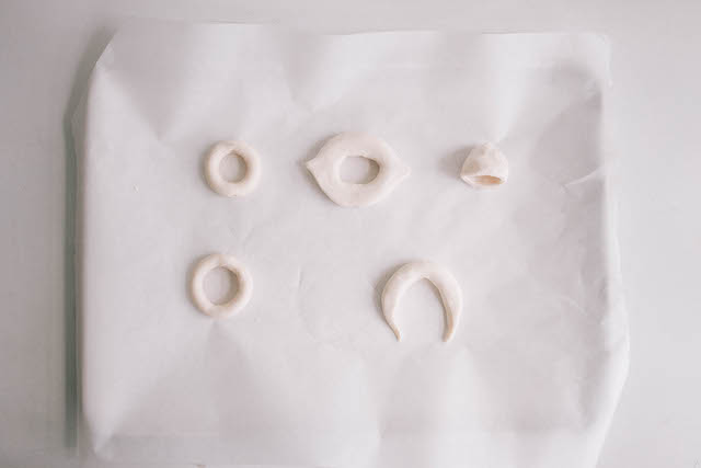 Bake the beads on a parchment-lined baking tray at 275 degrees Fahrenheit for 25 minutes.
