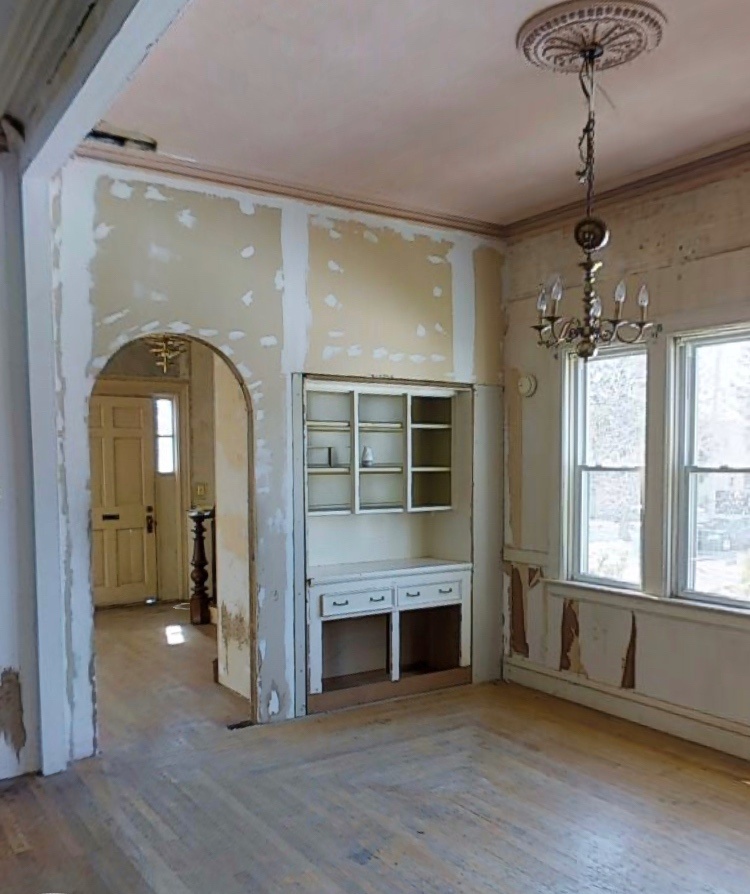 the before dining room was empty with a single old chandelier