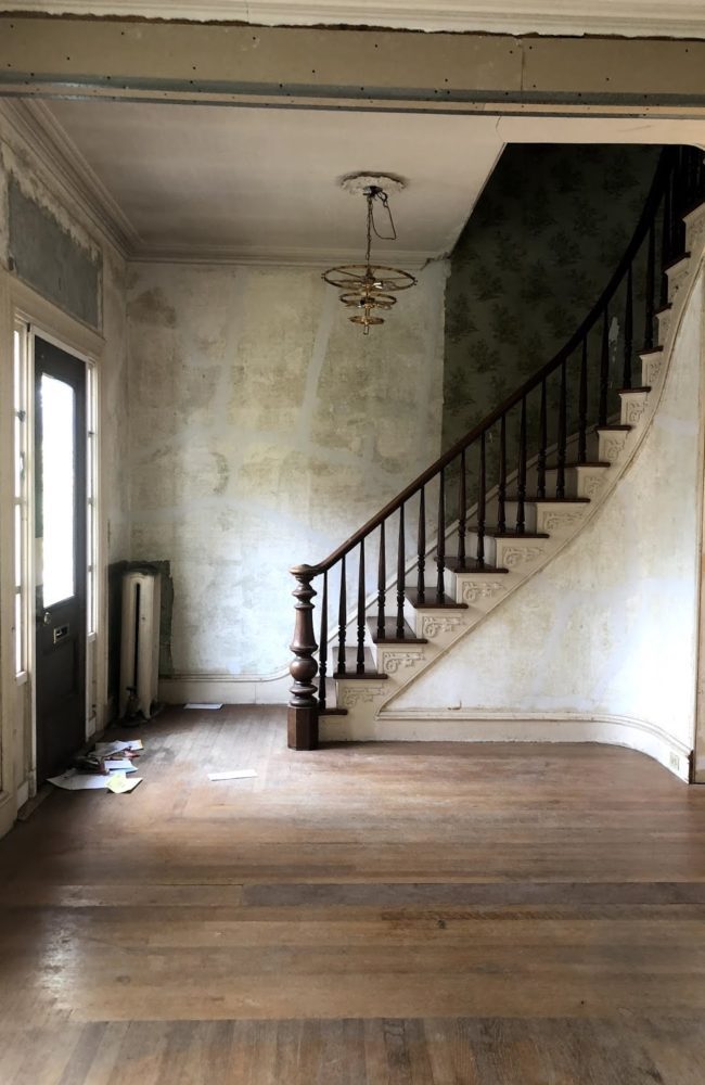 the original staircase in the dark entryway
