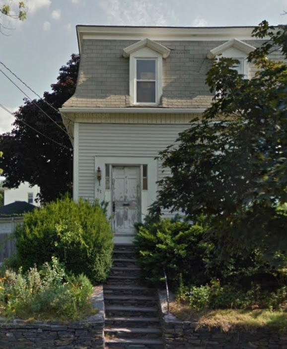 the exterior before the renovation, with a damaged siding