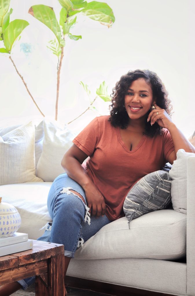 carli alves smiling on her couch
