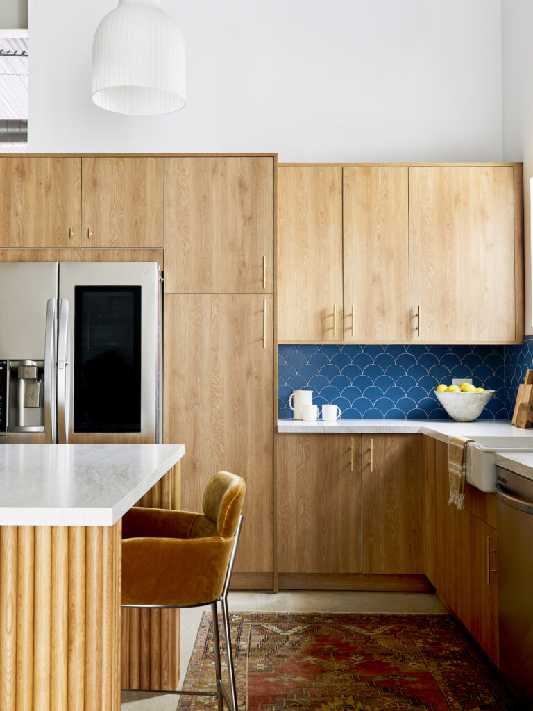 Walnut cabinets with blue backsplash