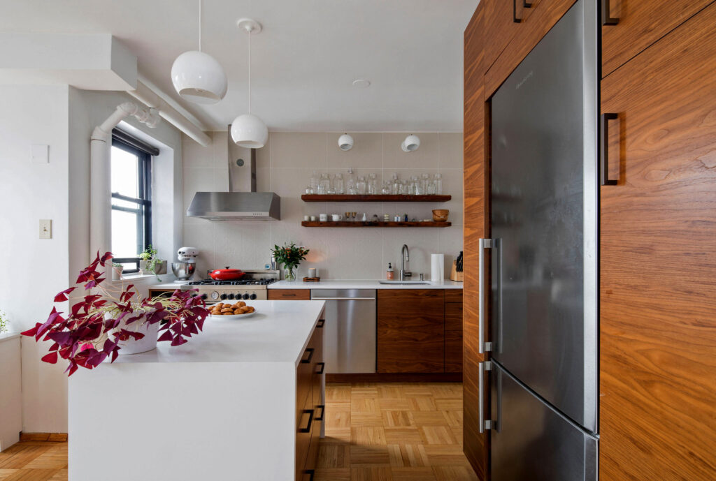 Walnut kitchen cabinets with yellow stools in East Hampton