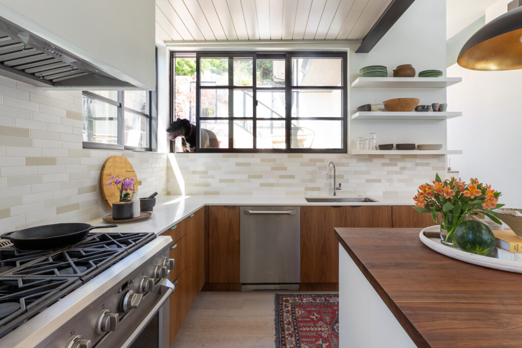 Walnut kitchen cabinets with beige and white subway tile backsplash