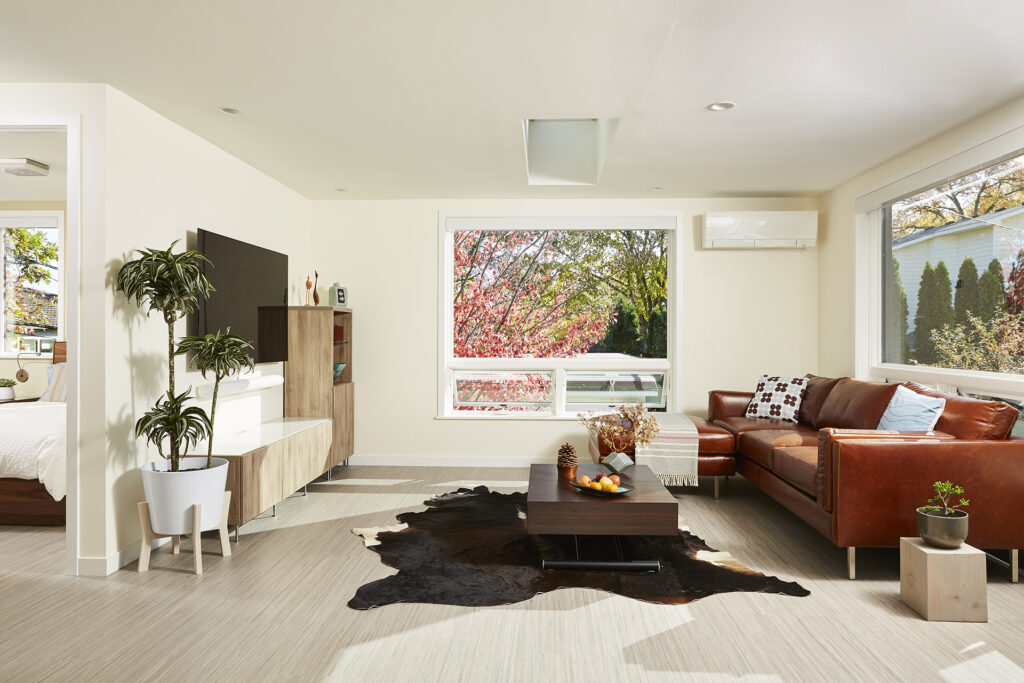 White living room with red sofa