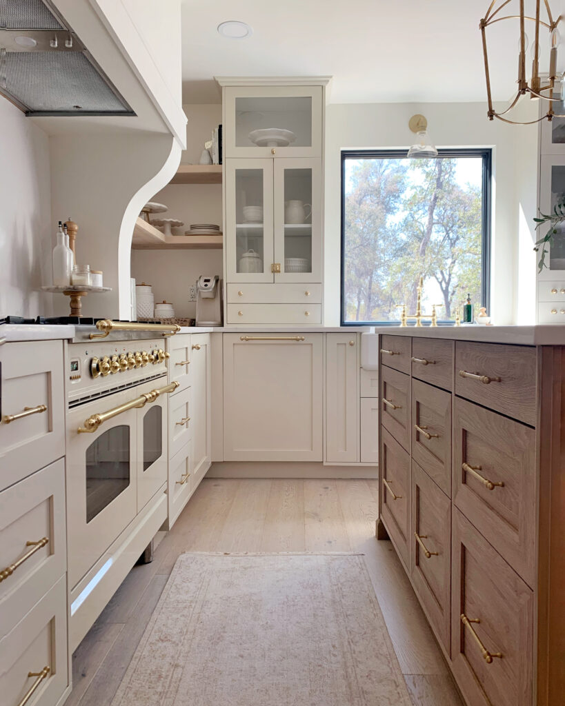 White kitchen cabinets with wood island
