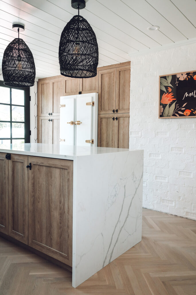 Wood kitchen island with black pendants