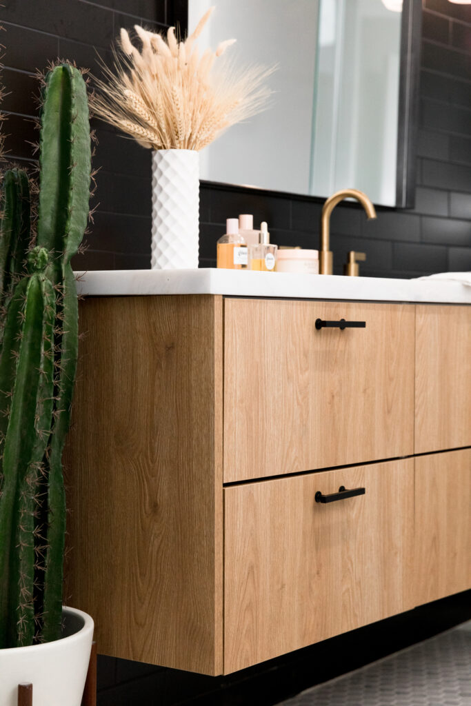 wood bathroom vanity in a black bathroom