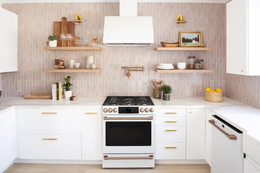 White kitchen cabinets with a pink backsplash