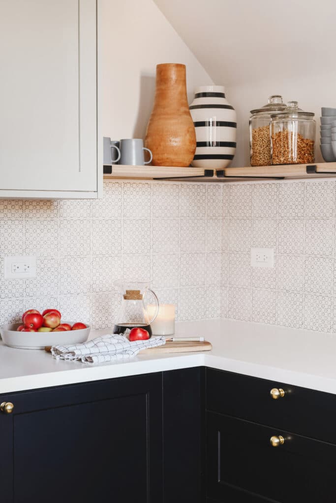 Two tone kitchen with black lowers and light grey uppers