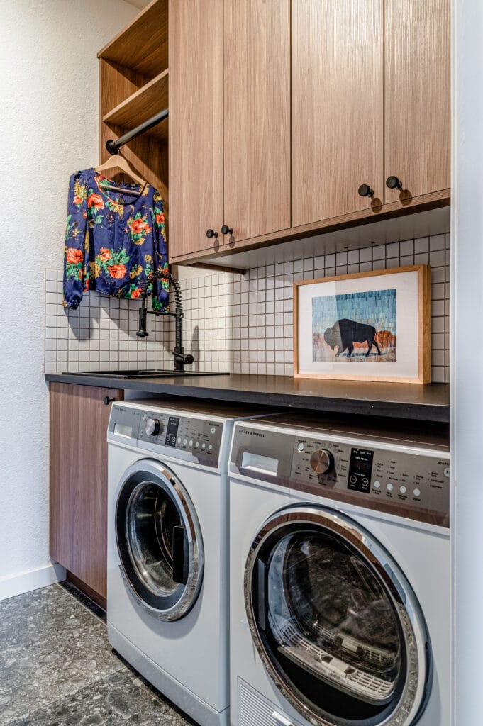 Laundry room with wood like cabinets