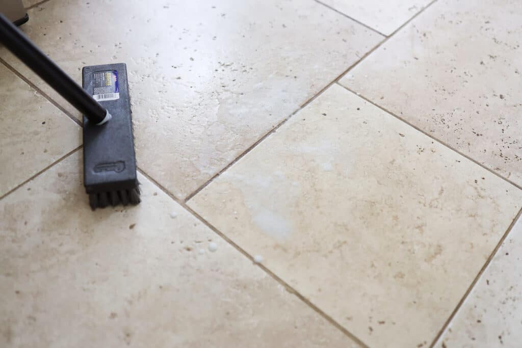 Broom cleaning tile floor