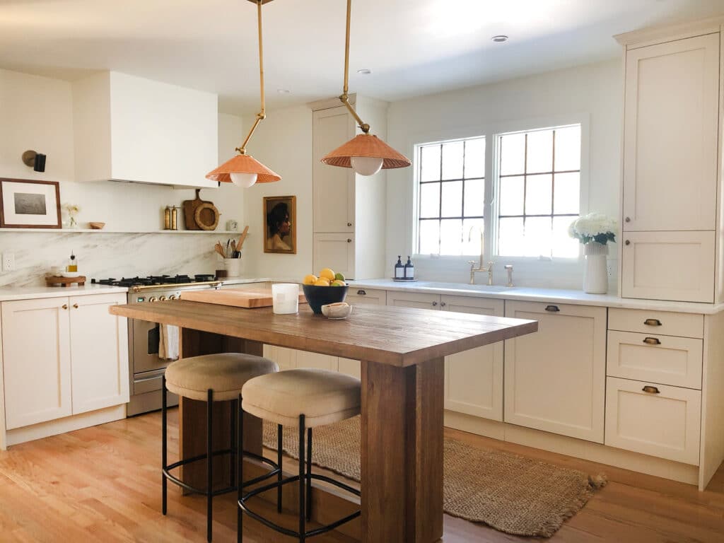 Cream kitchen with wood island with seating