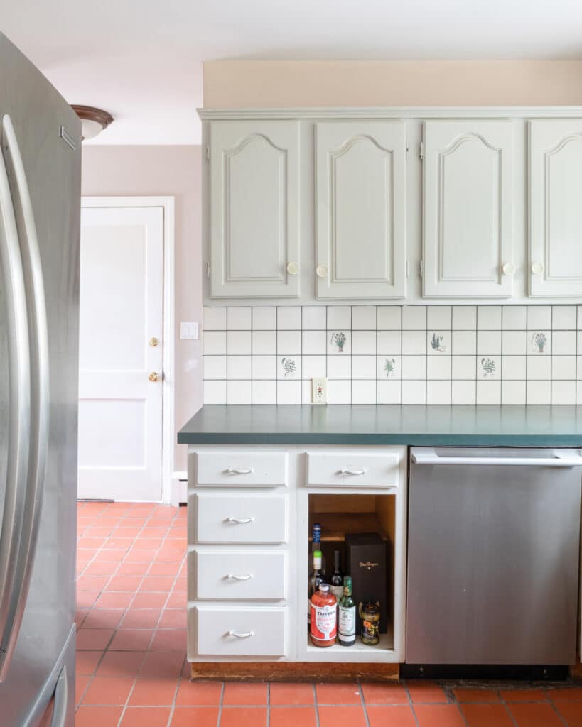 Before image of a white kitchen with terra cotta floors