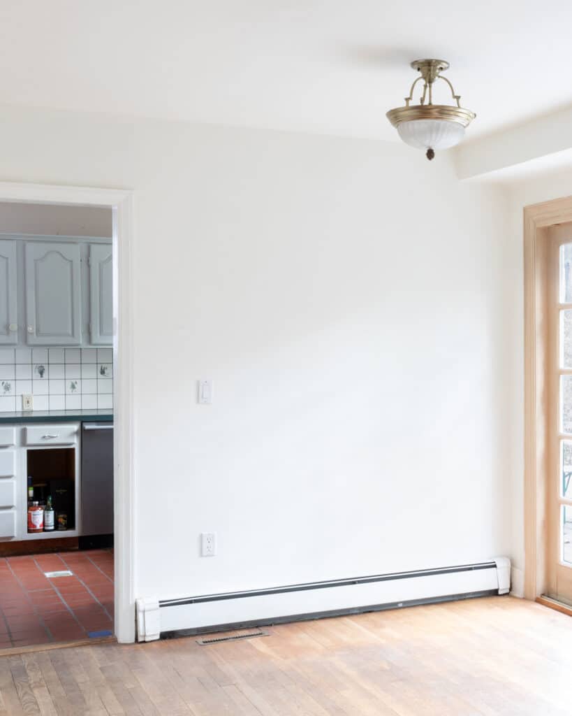 Before look at a breakfast nook area with kitchen off to the left