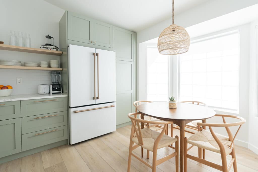 Dining room table in a sage green kitchen