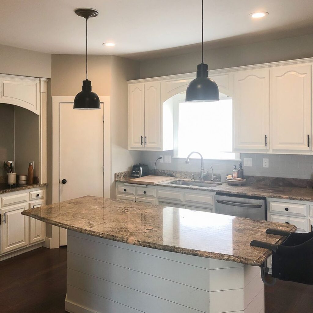 Before view of a white kitchen with granite counters