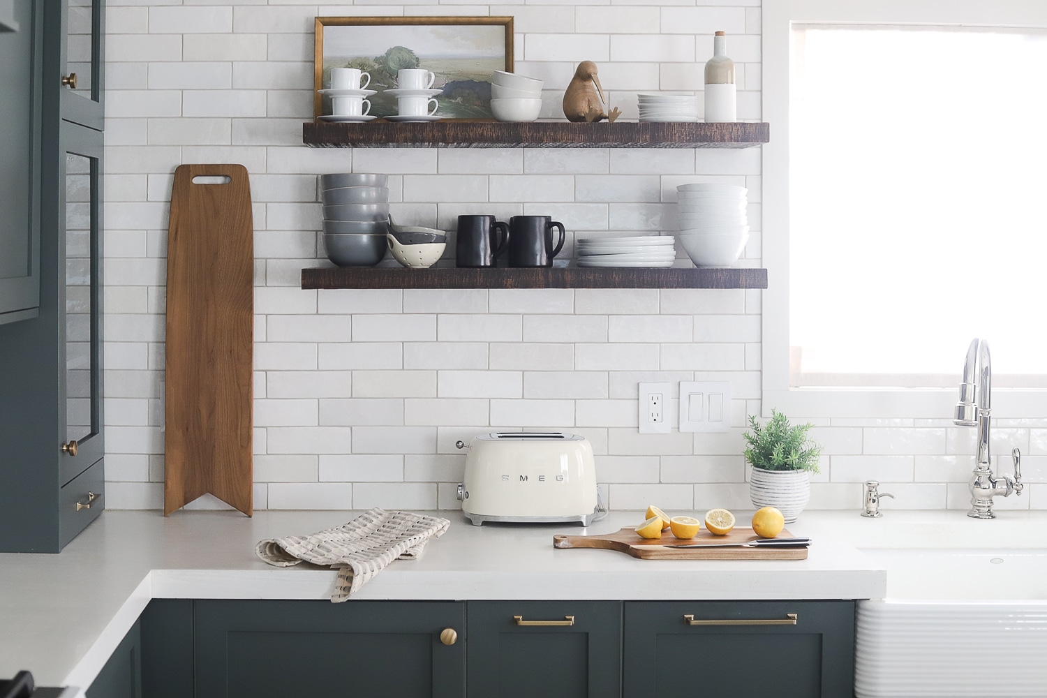 Gray green kitchen with white subway tile backsplash