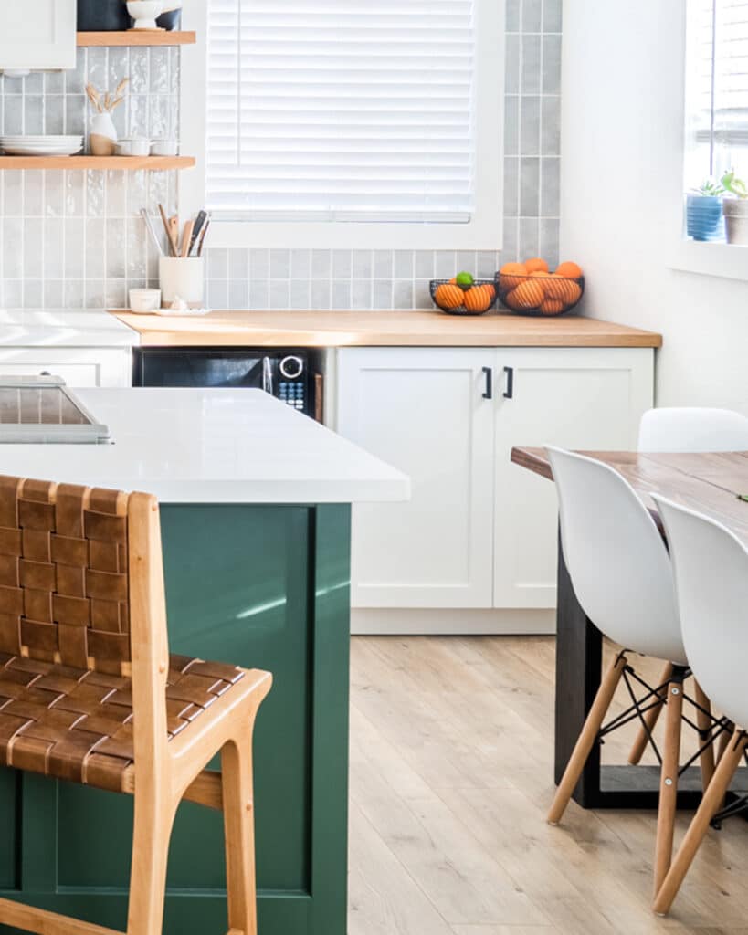 Green island and white cabinets in a kitchen