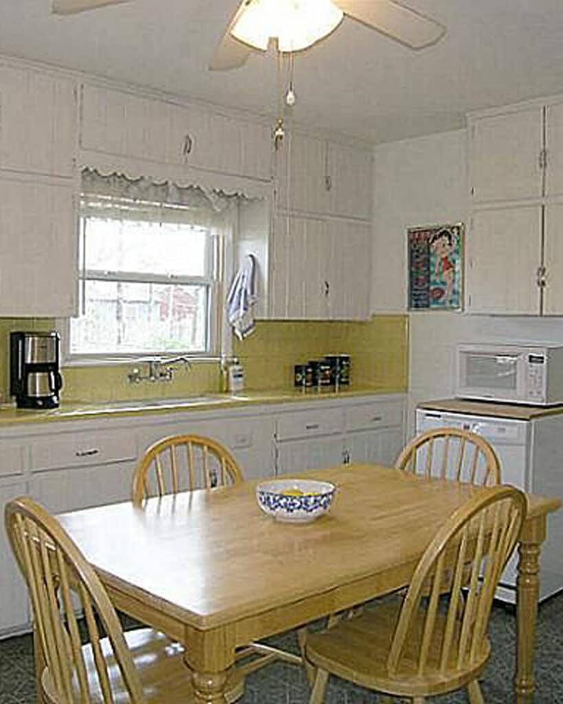 Kitchen before with yellow tile backsplash and white cabinets