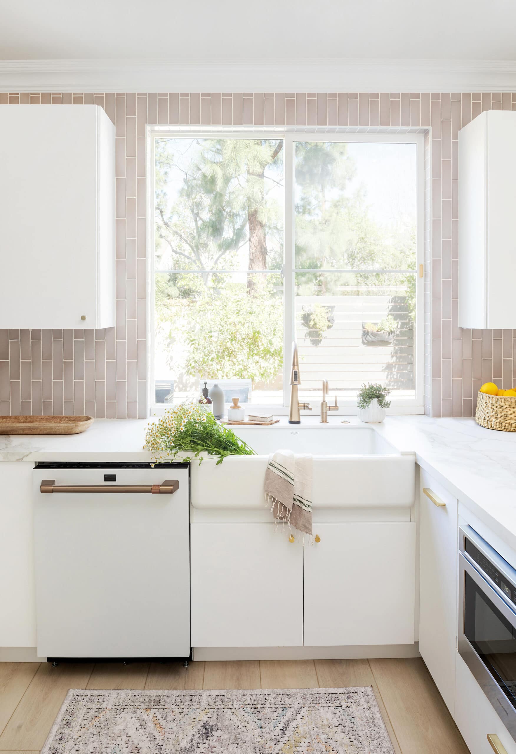 Pink and white kitchen with farmhouse sink