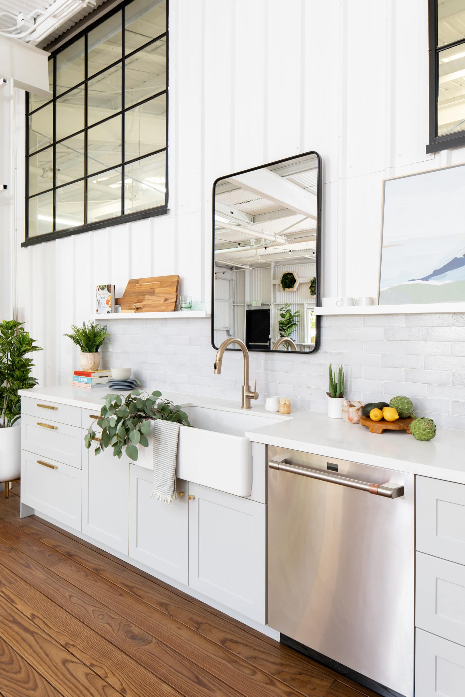 White kitchen with a mirror over the sink