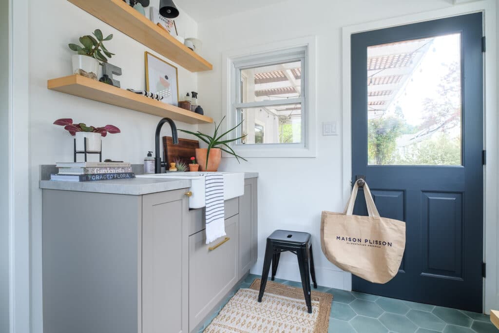 Mudroom with gray cabinets and a farmhouse sink