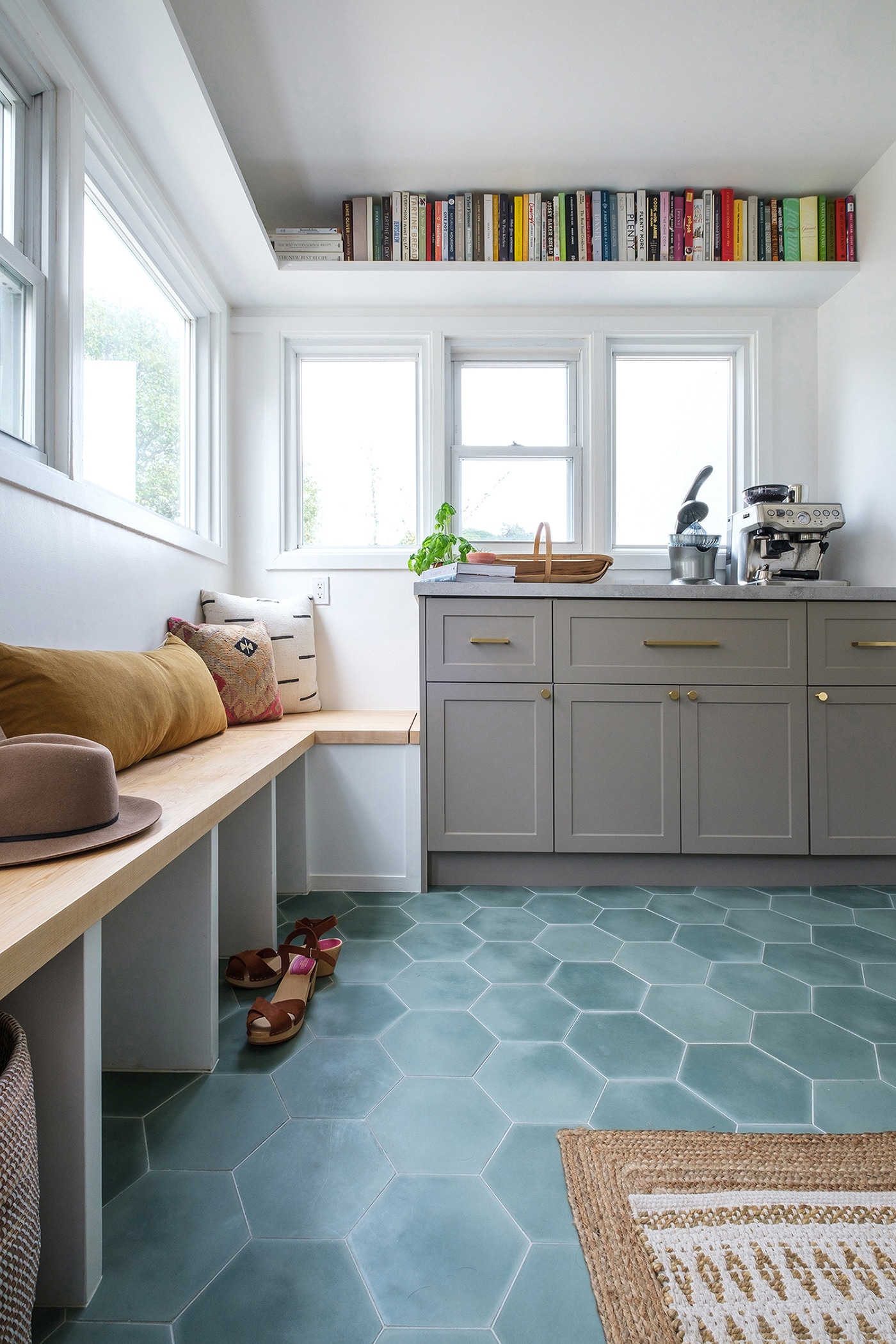 Mudroom with blue floor tile and gray cabinets