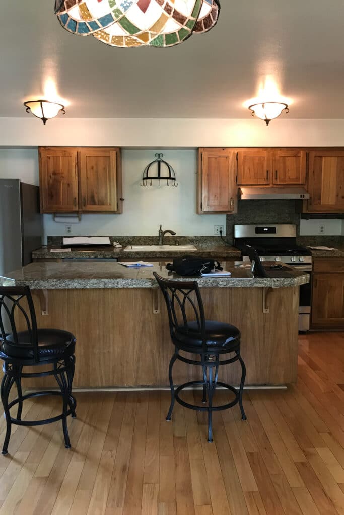 Before view of lights on kitchen with dark cabinets